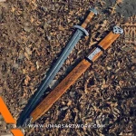 Hand-forged Damascus steel Viking sword with distinctive blade patterns, Sharp battle-ready sword inspired by Norse warriors, High-quality medieval sword with full-tang construction, Authentic replica with leather-wrapped grip and engraved guard, Display-worthy collectible combining Viking and medieval craftsmanship